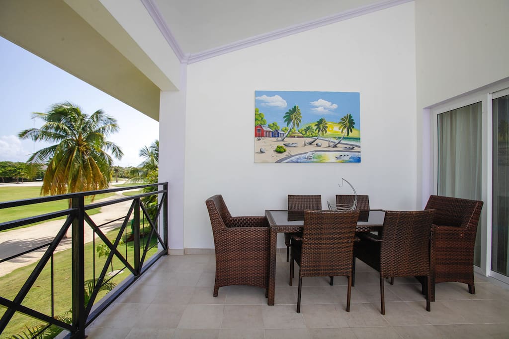 Comfortable settee on our huge balcony - a nice place to admire the nature. On the one side, there is an outdoor settee with 2 armchairs, and on the opposite side there is a dining table.