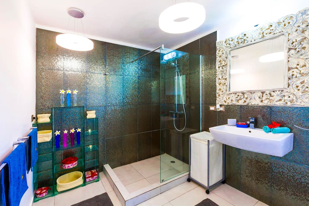 Modern shower for your comfort.It is next to your Master bedroom. It's very bright and fresh, free towels, shampoo, linen are included