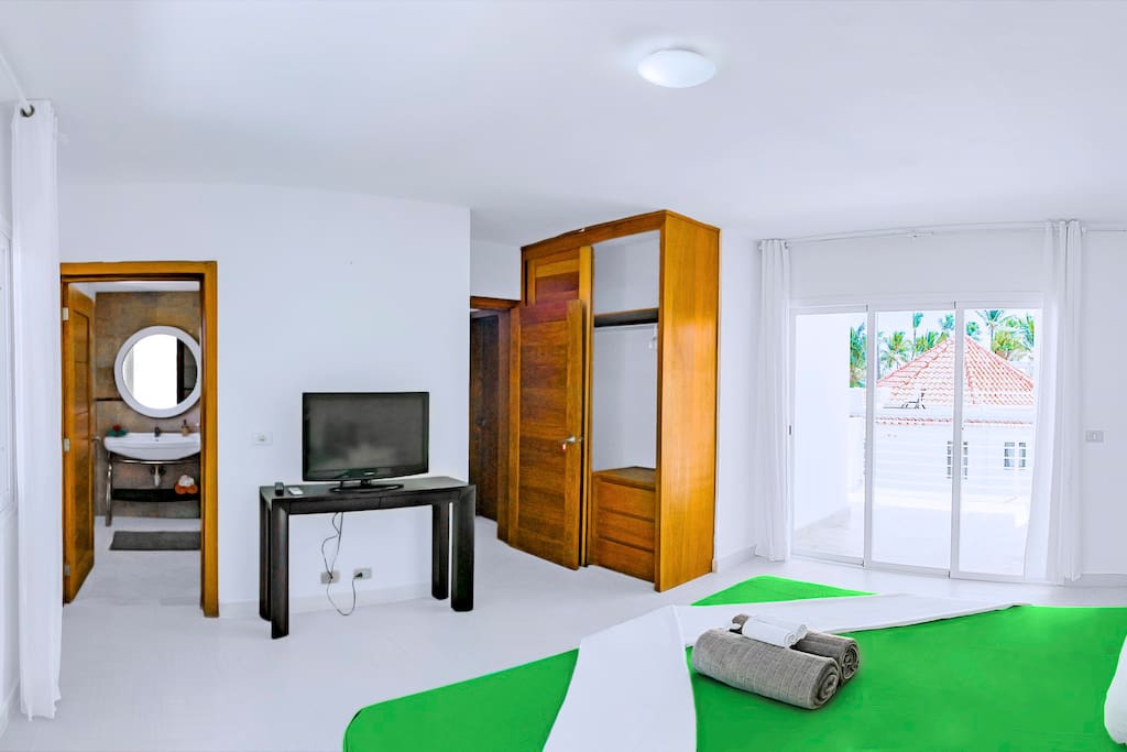 There are a comfortable king-sized bed, TV on the console table and a big wardrobe in the Master bedroom