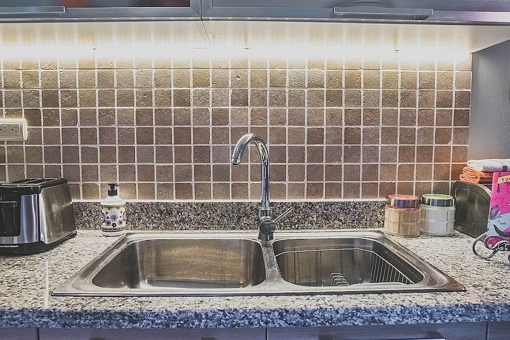 A fully-equipped kitchen features everything you might need: a microwave oven, coffee maker, teapot and kitchenware.