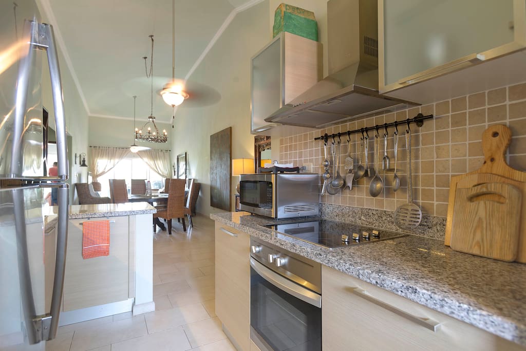 A fully-equipped kitchen features everything you might need: a microwave oven, coffee maker, teapot and kitchenware.