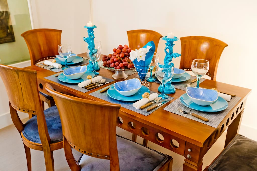 There is a dining area with a large table. You can cook your tasty meals and gather for dinner at the table.