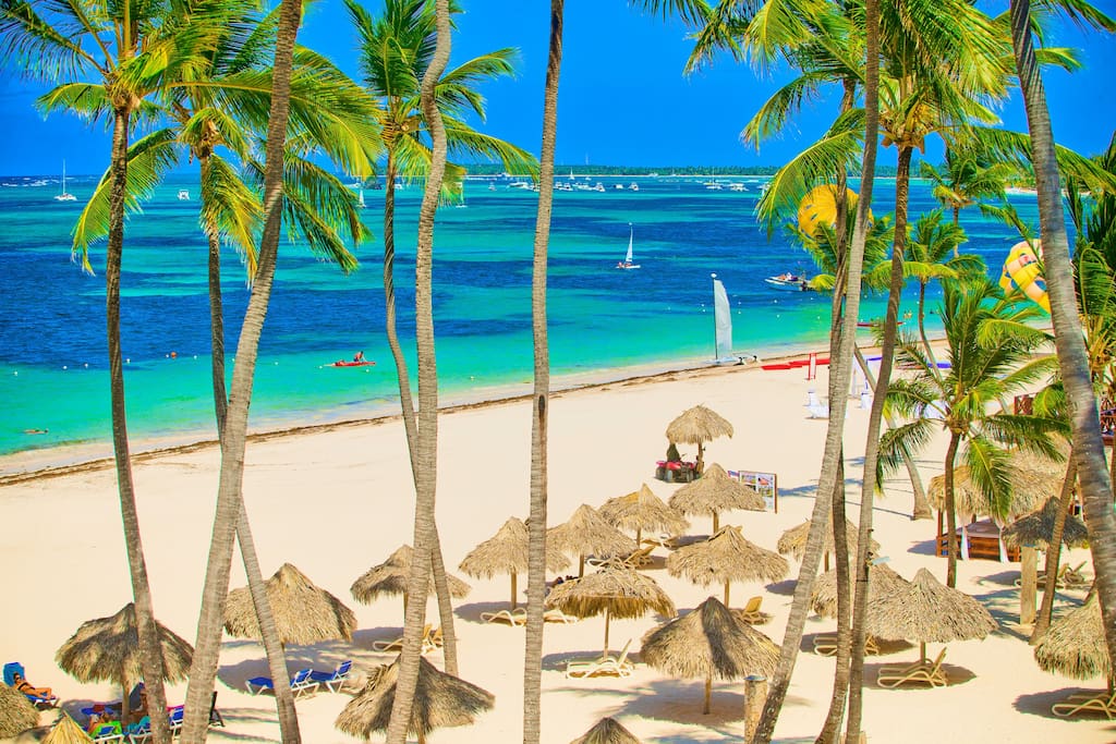 Tall palm trees, bright sun, white soft sand and amazing azure ocean. Punta Cana is a real paradise.