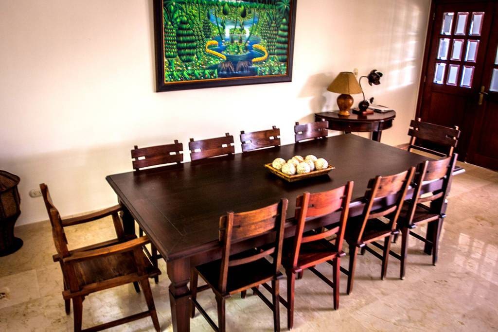 It is a dining area with a large table. Gather here all together and enjoy a delicious breakfast or dinner.