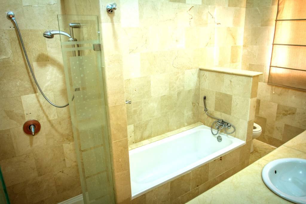 Your clean private bathroom with bath and shower. This villa has everything for a comfortable stay.