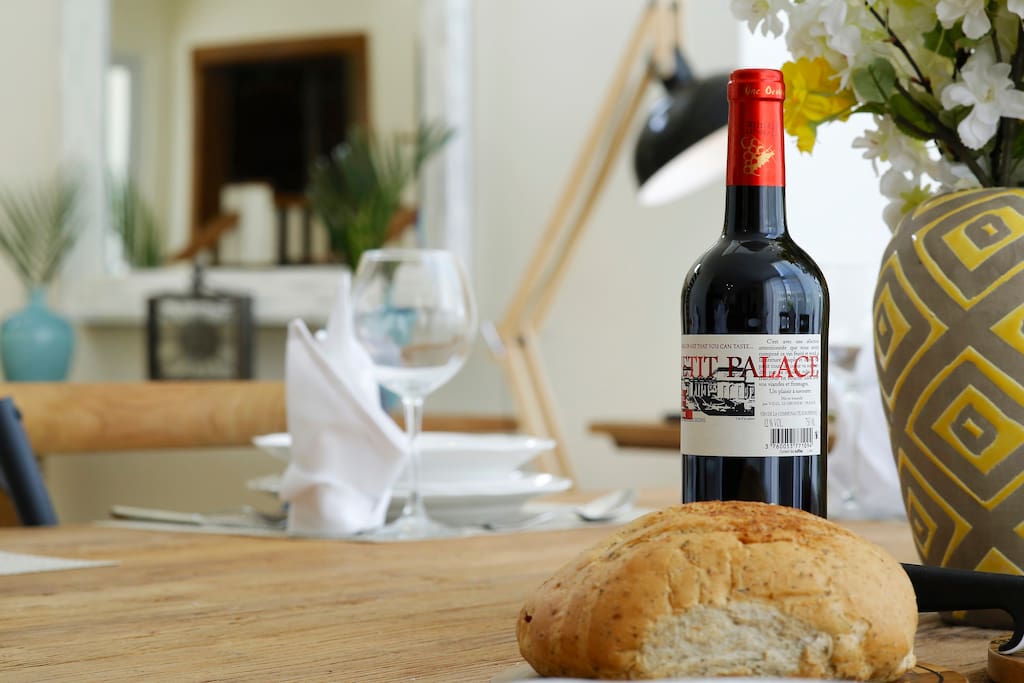 The dining area features a large table with utensils.