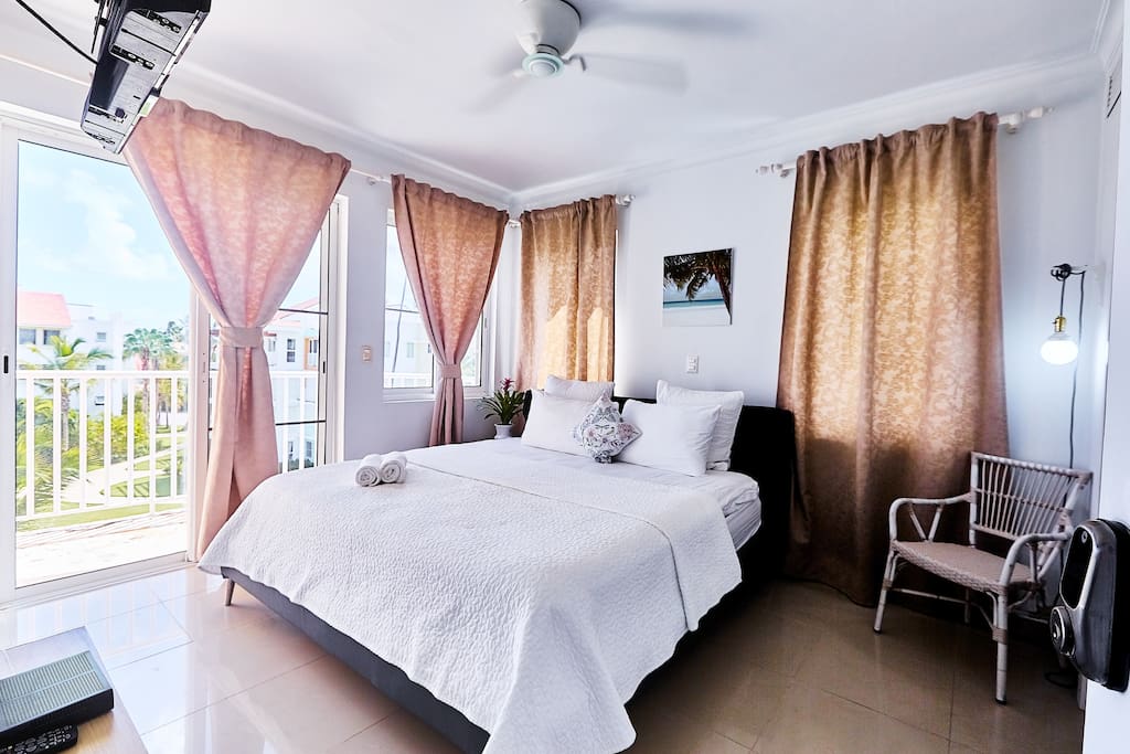 The bedroom is cute and full of natural light.