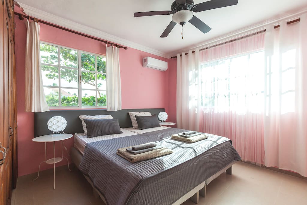 Right after the lilac room you'll find a pink room! Comfortable, super king size bed (200x200 cm). It can be divided into two singles. Always fresh linen. A kit of fresh towels. So, you can sleep well and enjoy your stay. Every room has a spacious closet so that you can store your things. Lamps, ceiling fan, and air conditioner in every room will make your stay comfortable and enjoyable