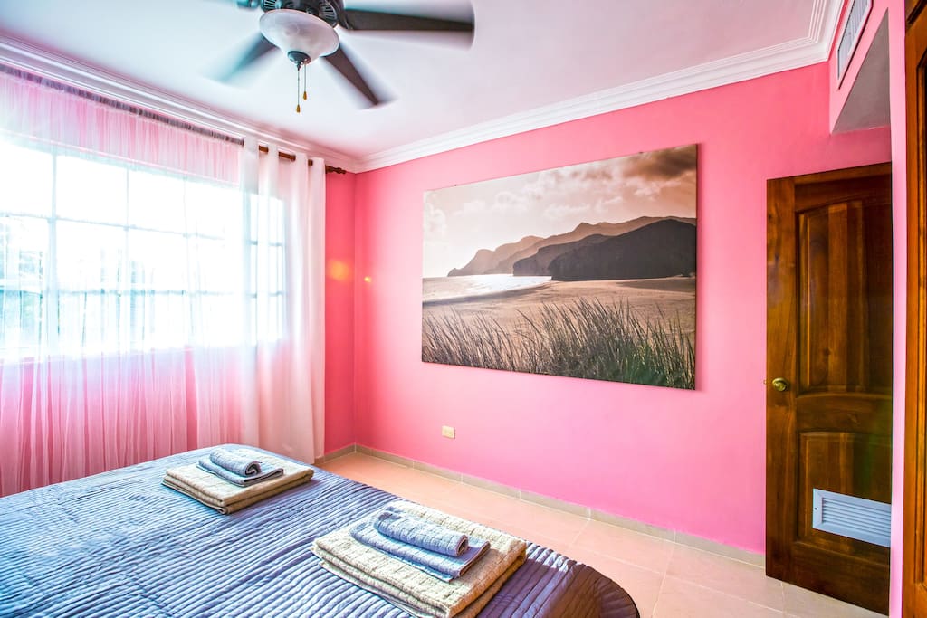 Pink (Rose) Room. Comfortable, super king size bed, fresh linen. A kit of fresh towels so that you can sleep well and enjoy your stay. Every room has a spacious closet so that you can store your things. Lamps, ceiling fan, and air conditioner in every room will make your stay comfortable and enjoyable. Bed size 200 cm x 200 cm. It can be divided into two single beds. So, it's going to be very comfortable for you.