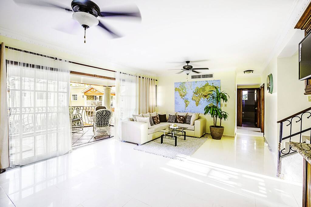 Living room. On your left, down the corridor, find the master bedroom. On the first level, you'll find a large living room with a spacious patio overlooking the pool. Here you can be comfortable and jump in the pool whenever you want.